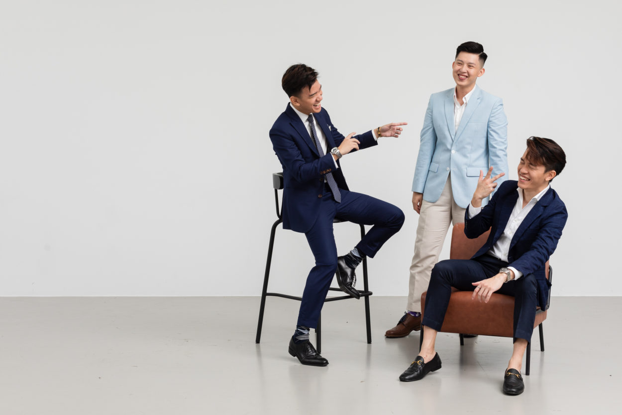 Professional studio shoot of 3 men in suits laughing