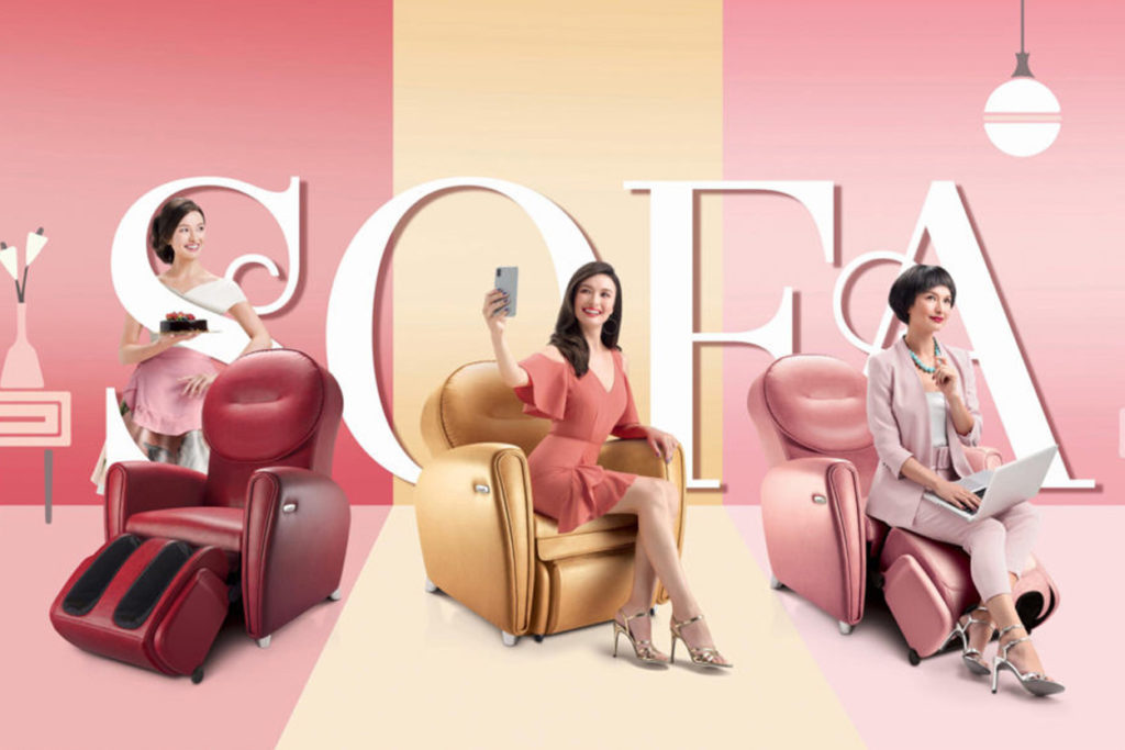 a commercial photograph of three massage chair sofas in the colours red, cream, and pink; each with a lifestyle model on it