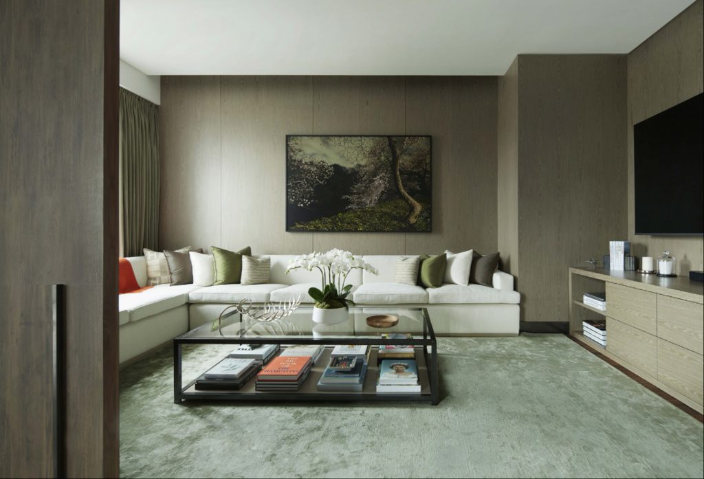 an interior photograph of a living room in a green and neutral analogous colour scheme