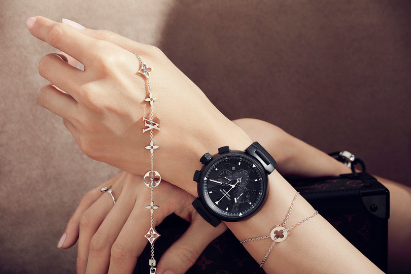 a commercial photograph of a black womens Louis Vuitton branded watch