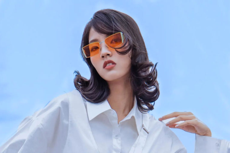 A fashion portrait of a woman in orange glasses by Jericho