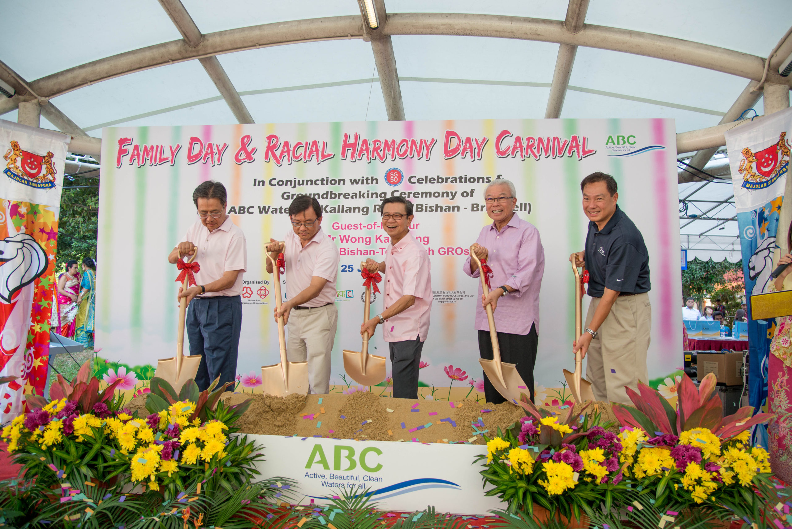 five leaders holding a spade for an event ceremony